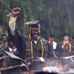 Graduate Frederick Anderson stands in the pouring rain as President Barack Obama acknowledges him during the Morehouse College 129th Commencement ceremony, Sunday, May 19, 2013, in Atlanta. (AP Photo/Carolyn Kaster)