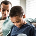 father and son using tablet
